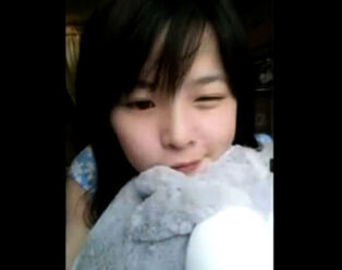 Cute chinese teen blinking above webcam